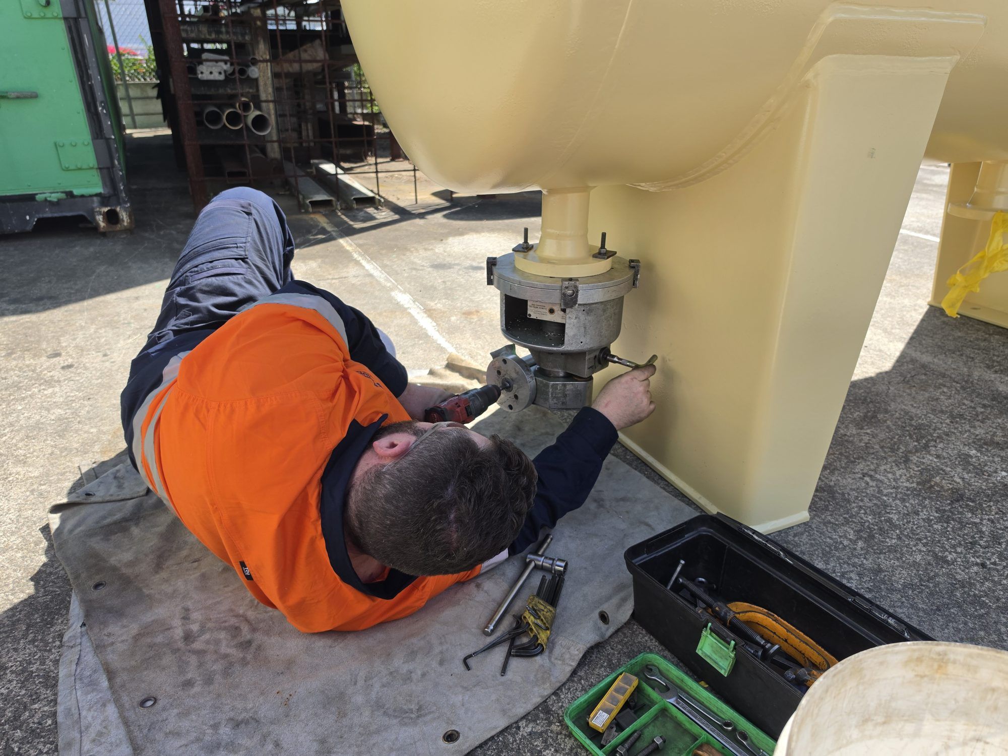 BLJ technician machining a small bore nozzle flange on the underside of a separator vessel